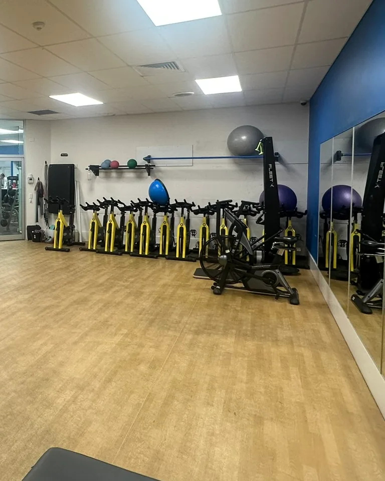The group fitness studio at Berri, with spin bikes along one wall, medicine balls and a sprung wooden floor